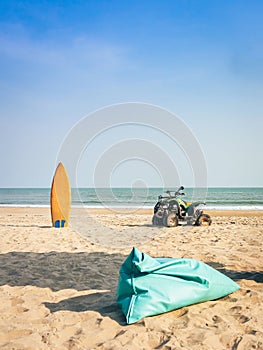 Vintage green ATV on the sandy beach. Quad ATV all terrain vehicle parked on beach, Motor bikes ready for action with summer sun