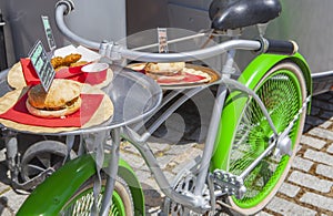 Vintage green bike used for offer meals beside food truck trailer
