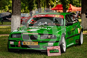 Vintage green BMW car with different modifications at an Auto Tuning Show