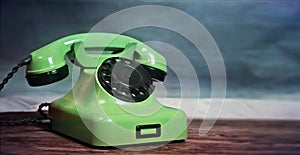 Vintage green cable telephone. Symbol of contact and landline telephony and communications