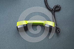 Vintage green telephone handset. phone receiver isolated on color background. old communication technology