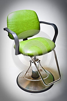 Vintage green vinyl covered barber shop chair. photo