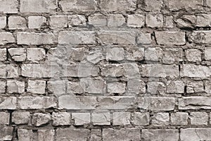 Vintage grey brick wall texture. White old cement wall background. Pattern with gray dilapidated bricks. Blank concrete grunge wal