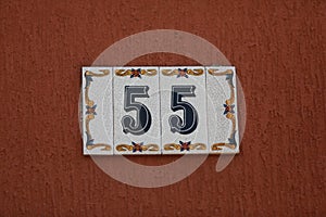 Vintage grunge square metal rusty plate of number of street address with number.