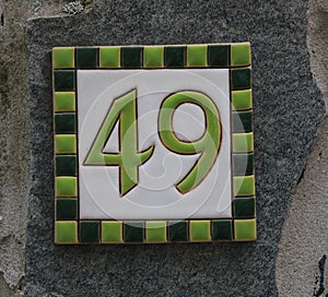 Vintage grunge square metal rusty plate of number of street address with number.