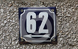 Vintage grunge square metal rusty plate of number of street address with number.