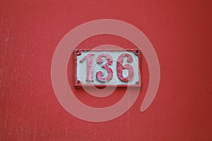 Vintage grunge square metal rusty plate of number of street address with number.