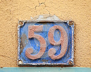 Vintage grunge square metal rusty plate of number of street address with number