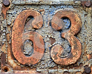 Vintage grunge square metal rusty plate of number of street address with number