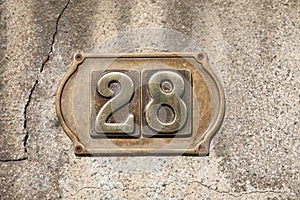 Vintage grunge square metal rusty plate of number of street address with number