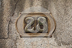 Vintage grunge square metal rusty plate of number of street address with number
