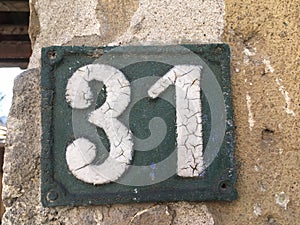 Vintage grunge square metal rusty plate of number of street address with number