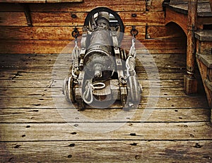 Vintage gun on ancient ship photo