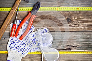 Vintage hammer, pliers, screwdriver, tape measure, gloves and sa