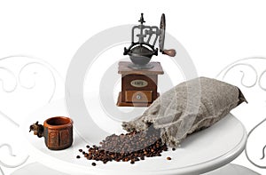 Vintage hand coffee grinder. bag of scattered coffee beans