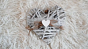 Vintage handmade heart on the soft white blanket. Romantic concept