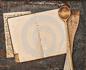 Vintage handwritten recipe book and old kitchen utensils