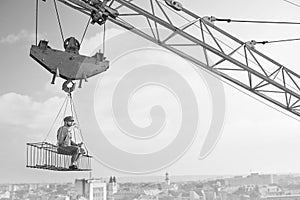 Vintage handyman having lunch on a crossbar hanging above the ci