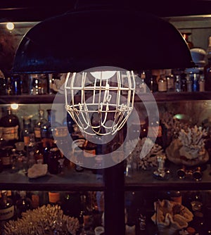 A vintage hanging lamp shining in a dark mysterious room.
