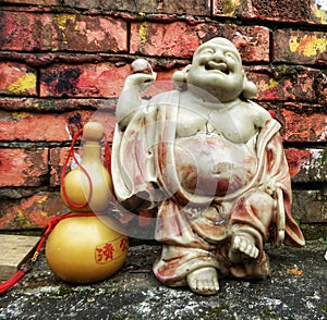 Vintage happy Buddha statue, Buddhist sculpture, Close up