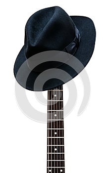 Vintage hat resting on a guitar fretboard