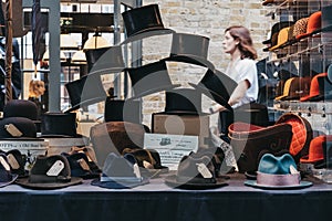 Vintage hats on sale at stall inside Spitalfields Market, London, UK