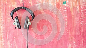 Vintage headphones hanging on grungy wall, listening,podcast, mu photo