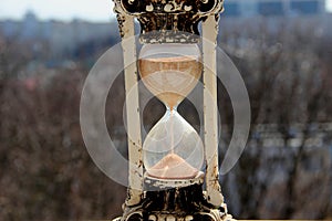 Vintage hourglass on a gray-brown background