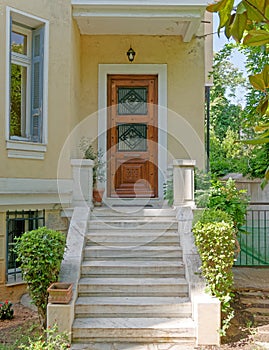 Vintage house luxurious entrance with marble stairs and wooden door