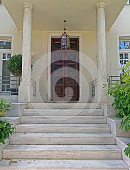 Vintage house luxurious entrance with marble stairs and wooden door