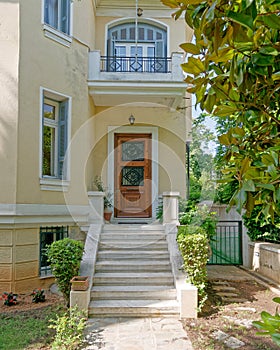 Vintage house luxurious entrance with marble stairs and wooden door