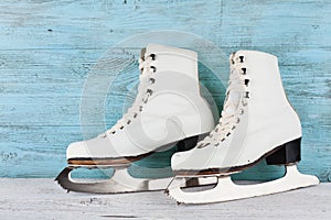 Vintage ice skates for figure skating on turquoise background