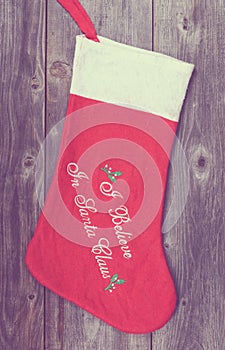 Vintage image of Christmas stocking on wooden background