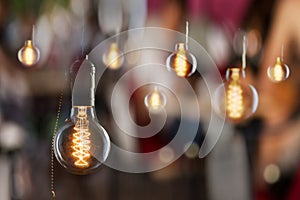 Vintage incandescent Edison type bulbs and window reflections