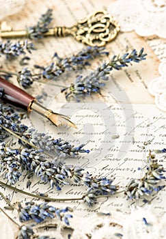 Vintage ink pen, key, lavender flowers and old love letters