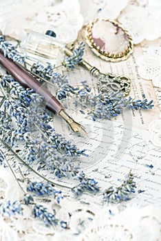 Vintage ink pen, key, perfume, lavender flowers and old love let