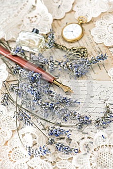 Vintage ink pen, key, perfume, pocket clock, lavender flowers