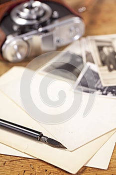 Vintage ink pen, old photos and camera