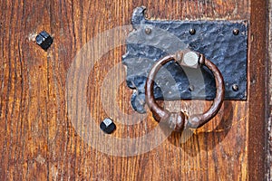 Vintage Iron Door Knocker on Rustic Wooden Door - Bishop Brute Seminary photo