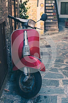 Vintage italian scooter in a alley of historic city center