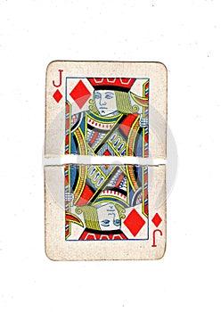 A vintage jack of diamonds playing card torn in half.