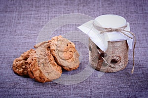 Vintage jar of white flour stands in the middle of a pile of grain o