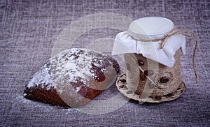 Vintage jar of white flour stands in the middle of a pile of grain o