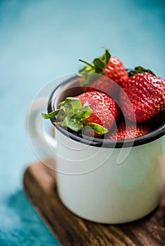 Vintage jat with fresh strawberries