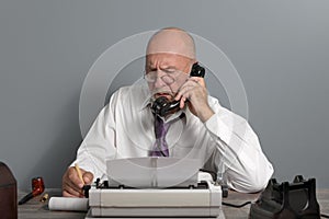 Vintage Journalist at work. Desk with telephone and typewriter. Writer editor