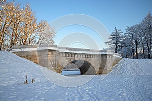 Vintage Karpin bridge of the Gatchina park on a january day. Russia