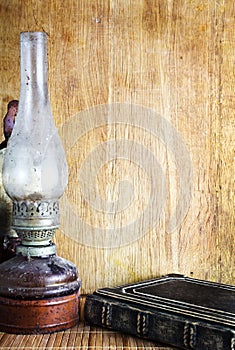 Vintage kerosene lamp and book