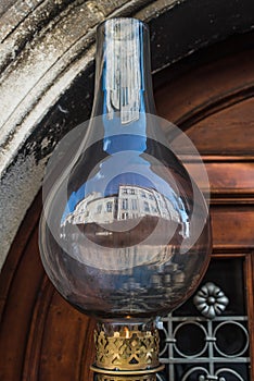 Vintage kerosene lamp . Old austran doors on background