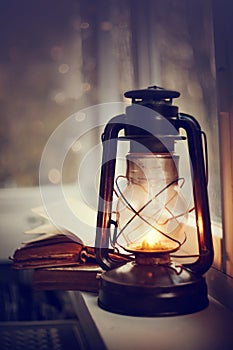 Vintage kerosene lamp and old books