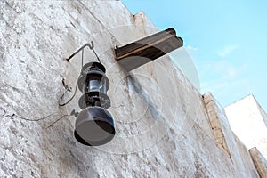 Vintage kerosene lamp on the white wall